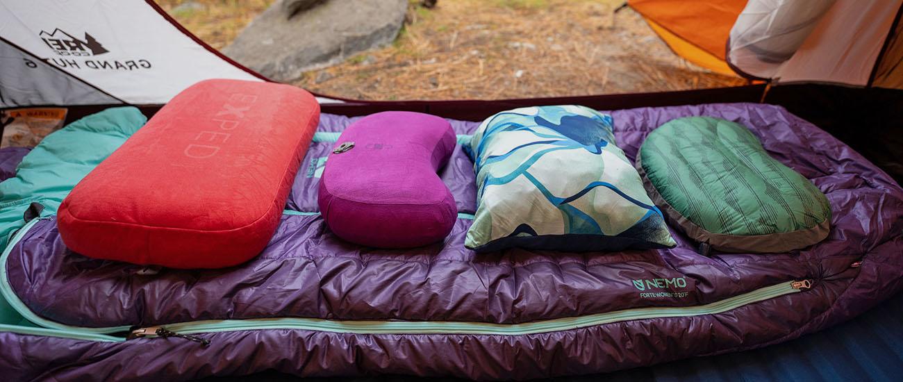 Camping and backpacking pillows (lined up on sleeping bag in tent)