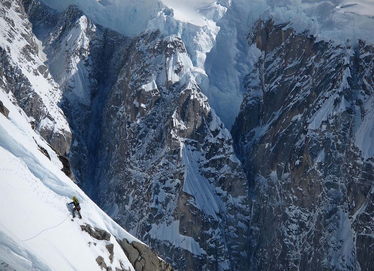 Mountaineering Boots (man climbing on steep snow)